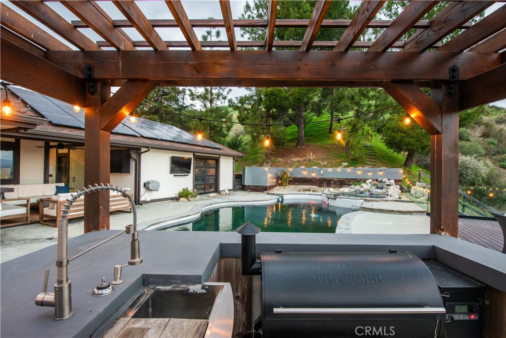 16337 Ravenglen Road Canyon Country, CA 91387 - Photo 38 of 50 a view of a patio with table and chairs and wooden floor