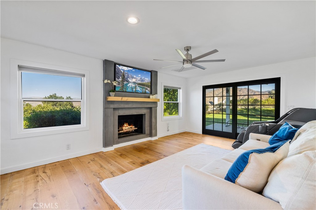16337 Ravenglen Road Canyon Country, CA 91387 - Photo 8 of 50 a living room with furniture large window and a fireplace
