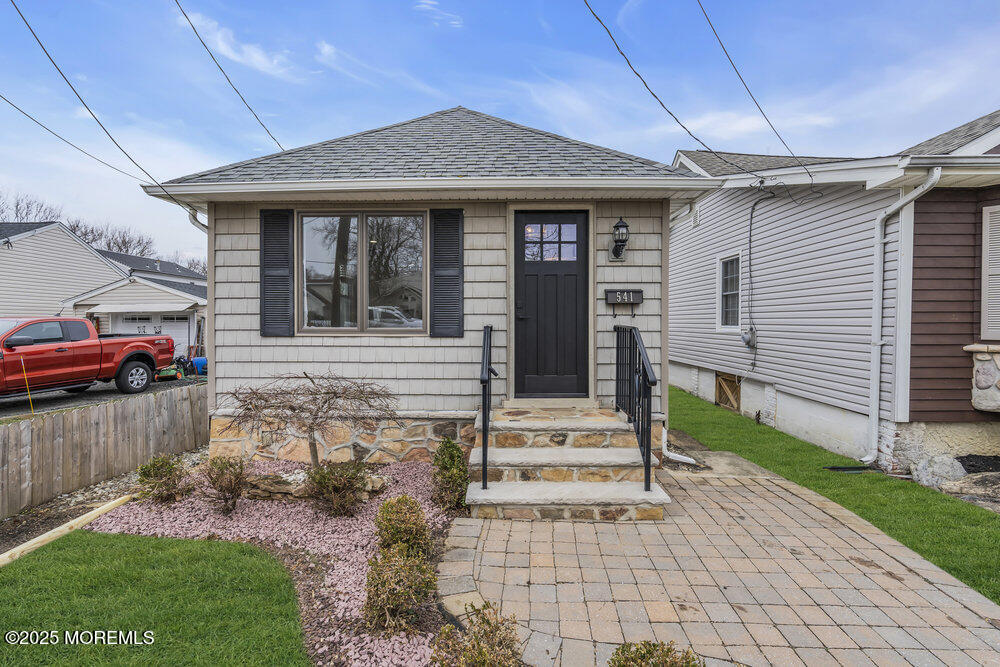 a front view of a house with a garden