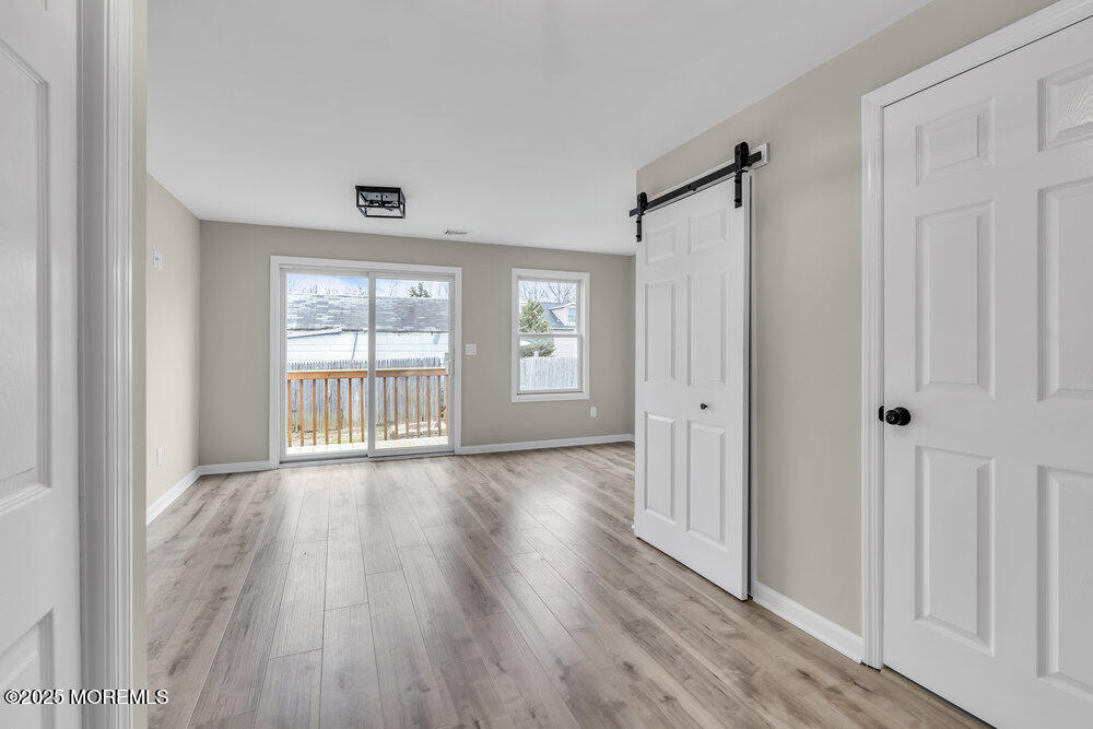 541 Ocean Boulevard Leonardo, NJ 07737 - Photo 20 of 29 a view of an empty room with wooden floor and a window