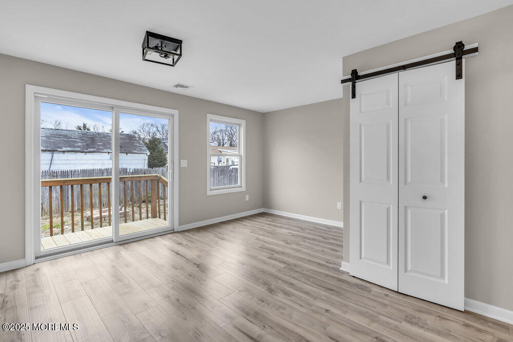 541 Ocean Boulevard Leonardo, NJ 07737 - Photo 22 of 29 a view of an empty room with a window and wooden floor