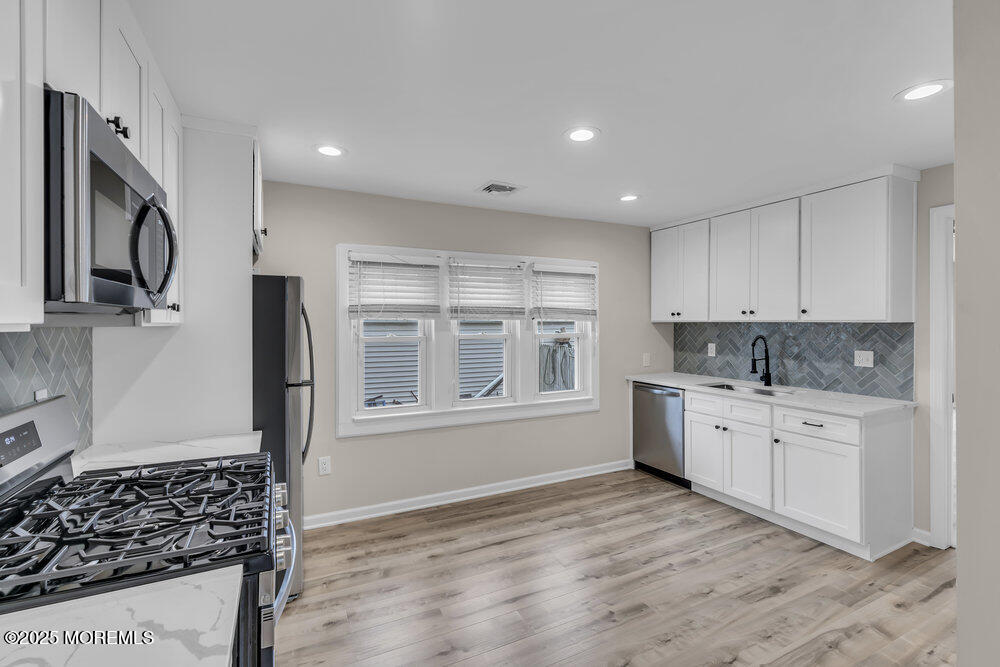 541 Ocean Boulevard Leonardo, NJ 07737 - Photo 24 of 29 a kitchen with stainless steel appliances granite countertop a stove a sink and a refrigerator
