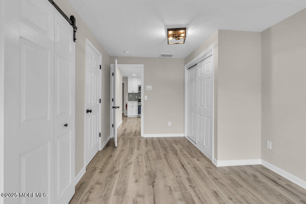 541 Ocean Boulevard Leonardo, NJ 07737 - Photo 8 of 29 a view of a hallway with wooden floor and staircase