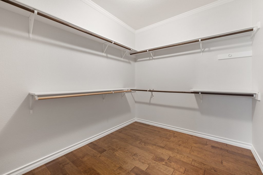 11129 Bastogne Loop Austin, TX 78739 - Photo 21 of 40 The oversized primary closet feels more like a dressing room than simple storage.