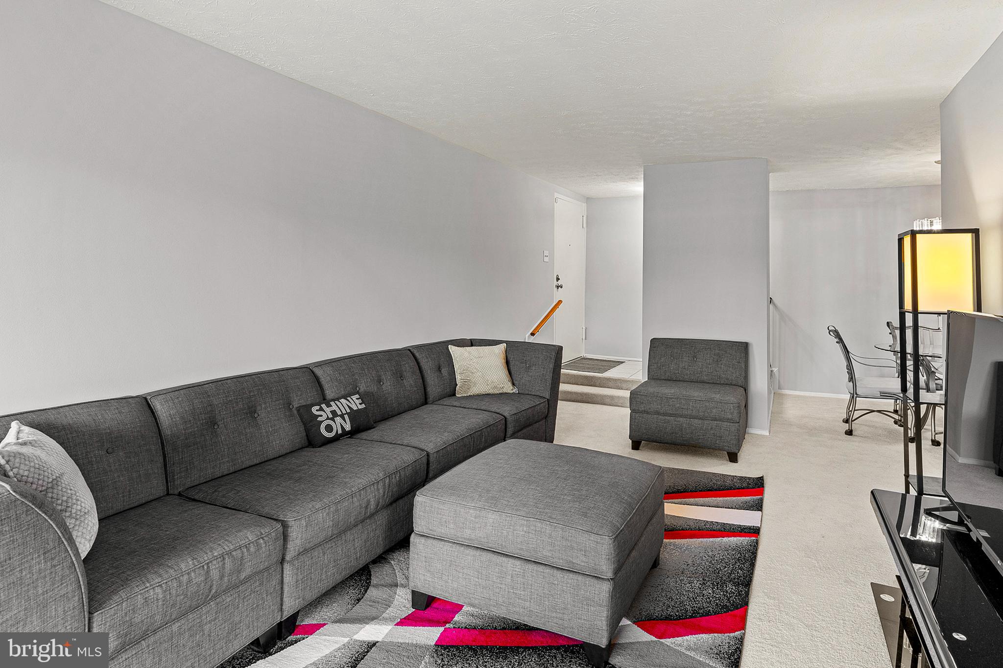 8005 Mandan Road, Unit 302 Greenbelt, MD 20770 - Photo 7 of 22 a living room with furniture and a flat screen tv