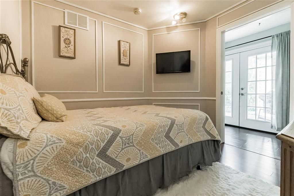 2939 Hunters Point Lane Carrollton, TX 75007 - Photo 11 of 29 a bedroom with a bed and a flat screen tv