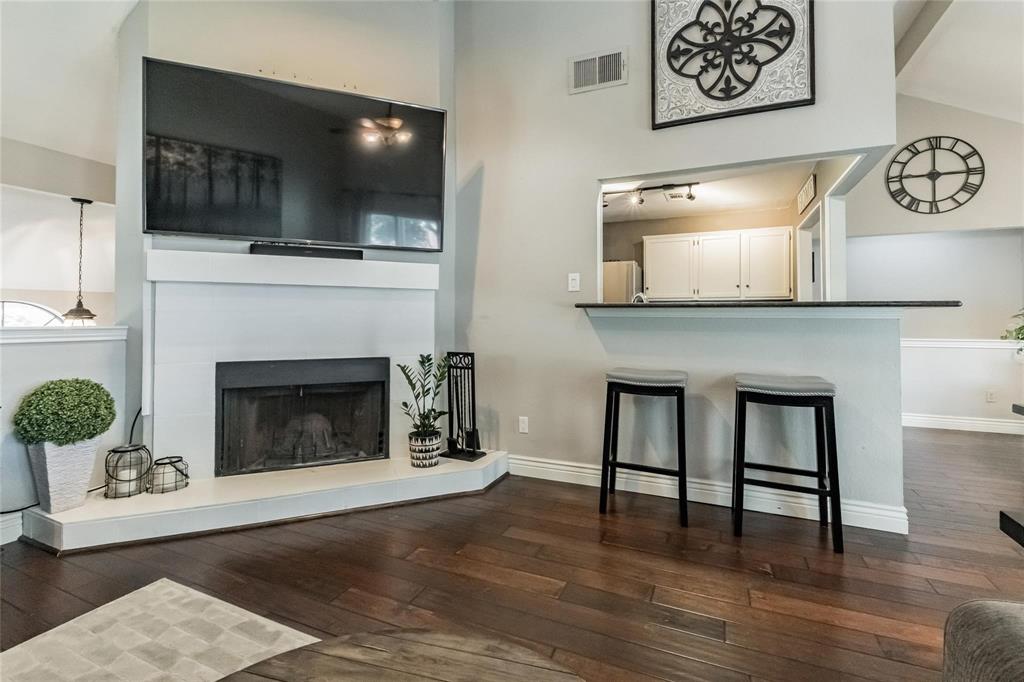 2939 Hunters Point Lane Carrollton, TX 75007 - Photo 16 of 29 a living room with a fireplace and a flat screen tv