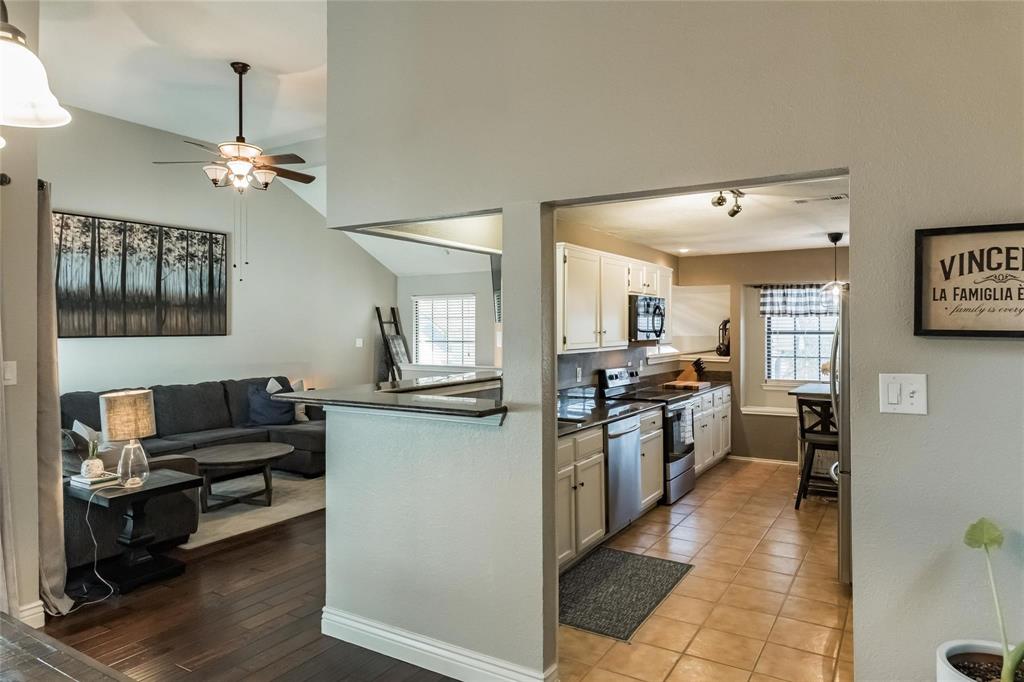 2939 Hunters Point Lane Carrollton, TX 75007 - Photo 29 of 29 a kitchen with granite countertop a refrigerator stove top oven and sink