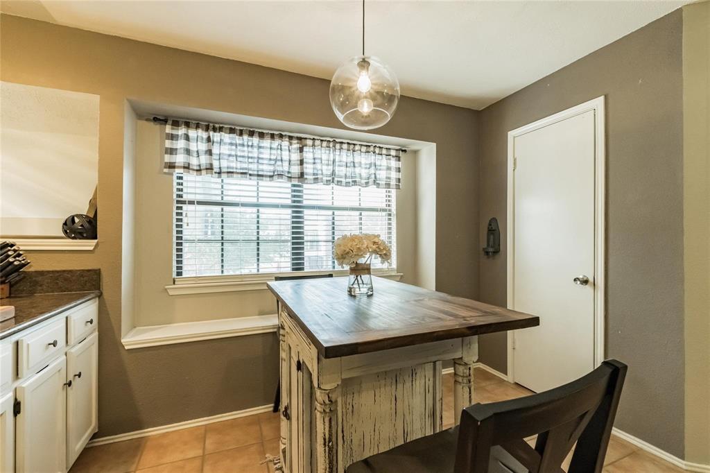 2939 Hunters Point Lane Carrollton, TX 75007 - Photo 19 of 29 a kitchen with a table chairs sink and wooden floor