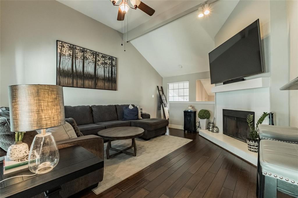 2939 Hunters Point Lane Carrollton, TX 75007 - Photo 4 of 29 a living room with furniture a flat screen tv and a fireplace