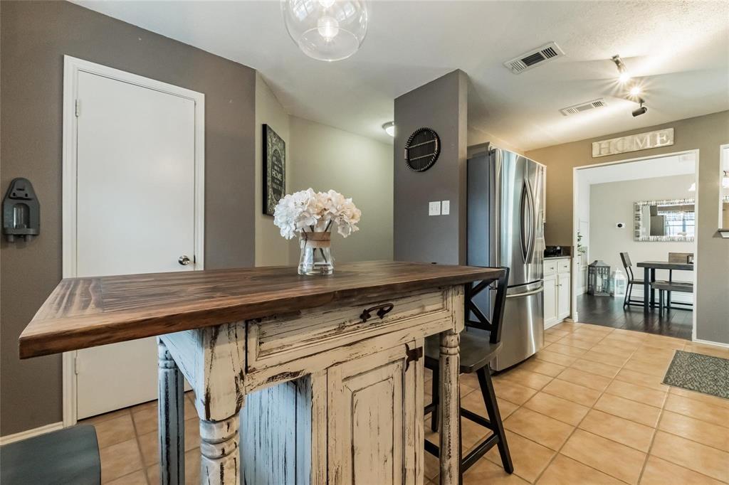 2939 Hunters Point Lane Carrollton, TX 75007 - Photo 8 of 29 a room with table chairs and wooden floor