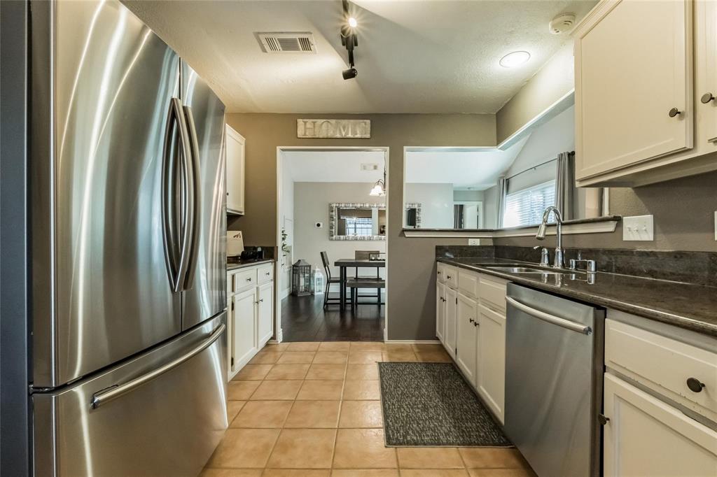 2939 Hunters Point Lane Carrollton, TX 75007 - Photo 9 of 29 a kitchen with stainless steel appliances granite countertop a refrigerator and a sink