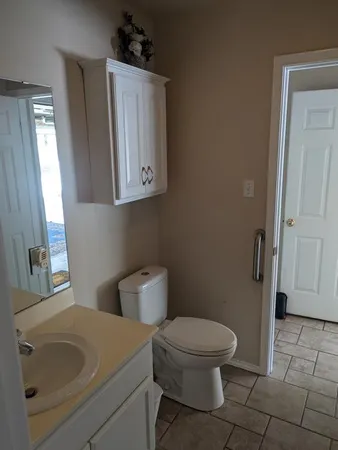 a bathroom with a toilet sink and shower