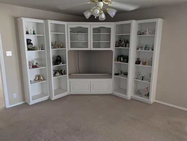 a view of an empty room with cabinet