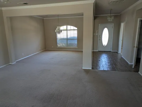 a view of a livingroom with wooden floor and a large window