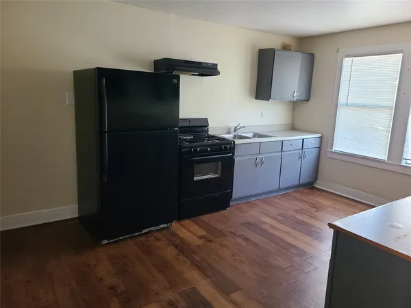 a kitchen with a sink and a refrigerator