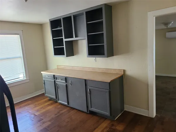 a room with cabinets and wooden floor