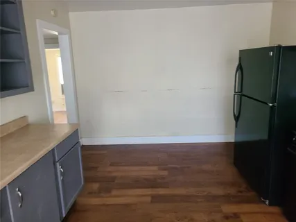 a view of a kitchen with a sink and a refrigerator