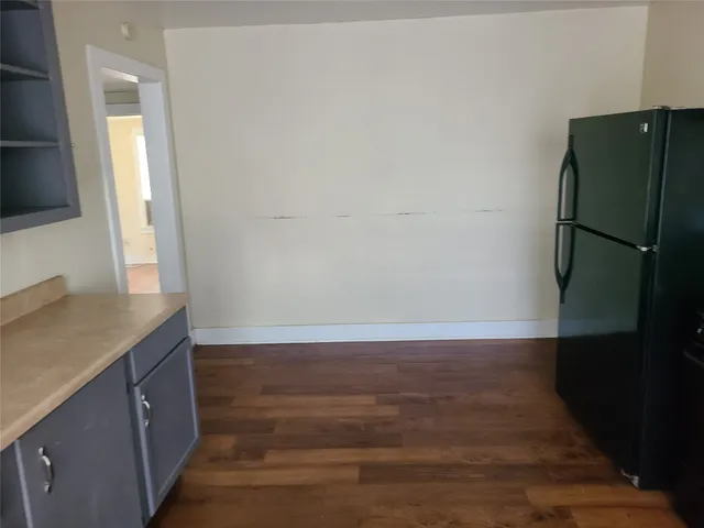 a view of a kitchen with a sink and a refrigerator