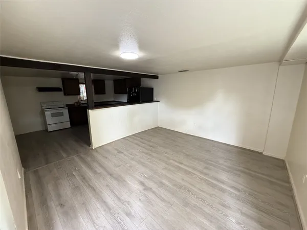 a view of a room with wooden floor