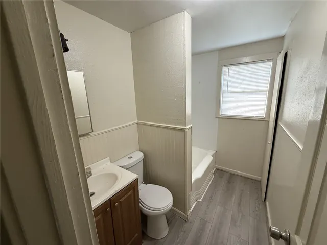 a white toilet sitting next to a small sink