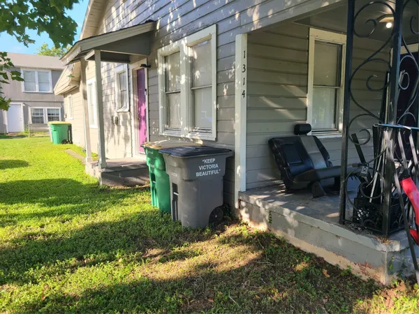 a view of backyard with wheel chair and potted plants
