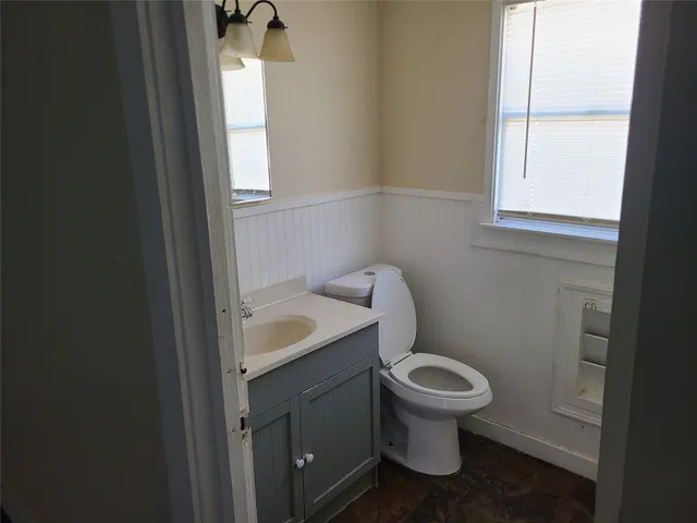 a white toilet sitting next to a bathroom sink