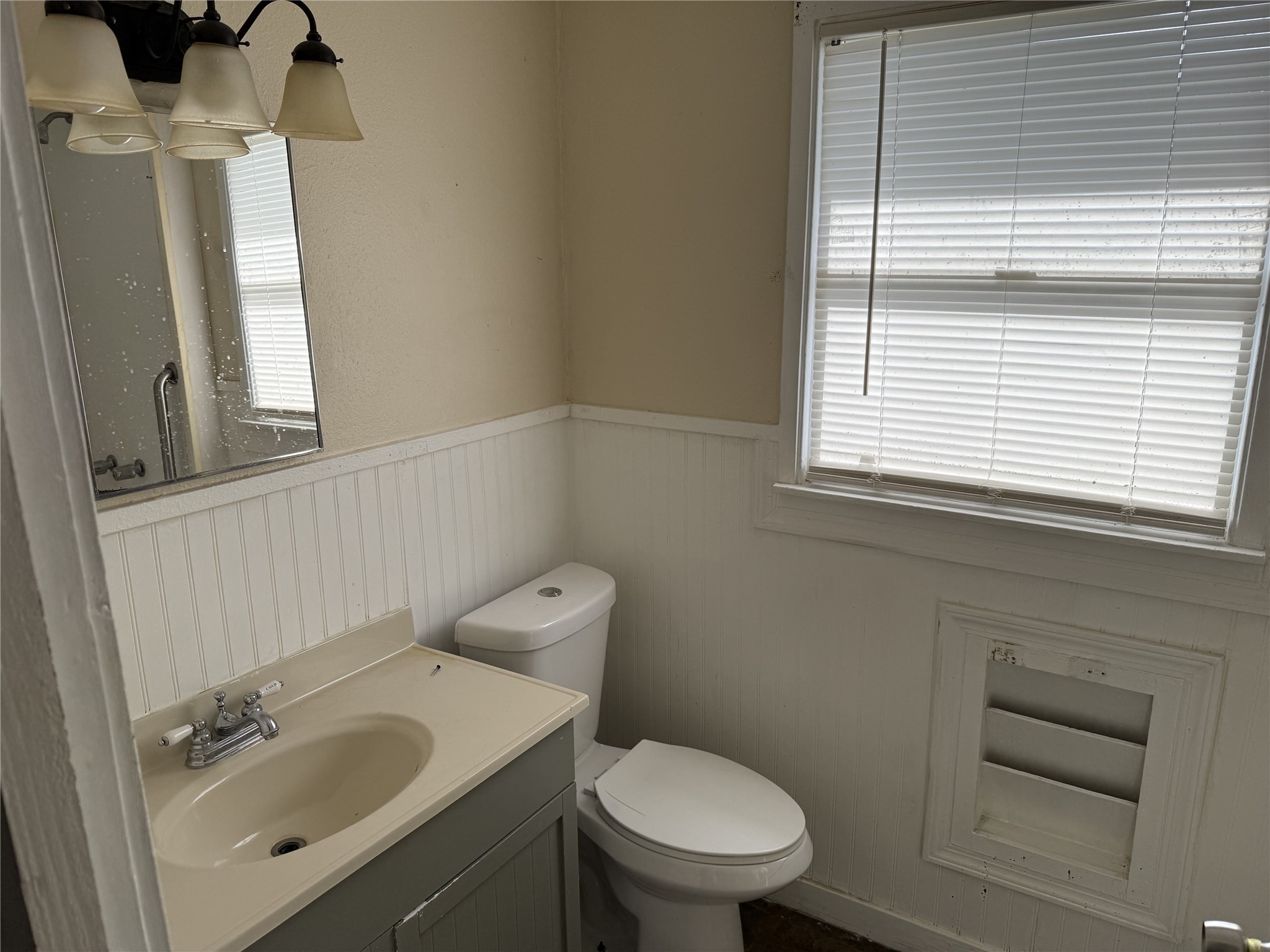 1314 East Power Avenue Victoria, TX 77901 - Photo 9 of 26 a bathroom with a sink a toilet and a window