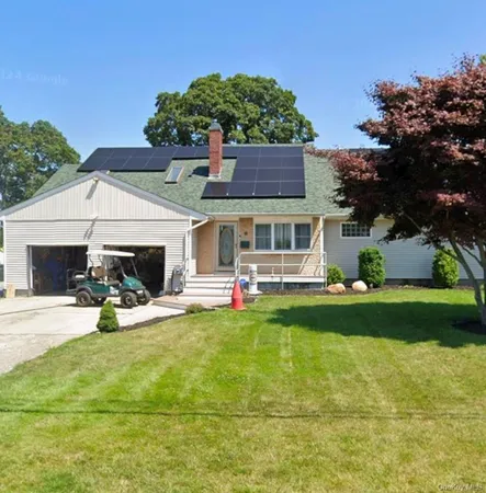 a view of a house with a patio and a yard
