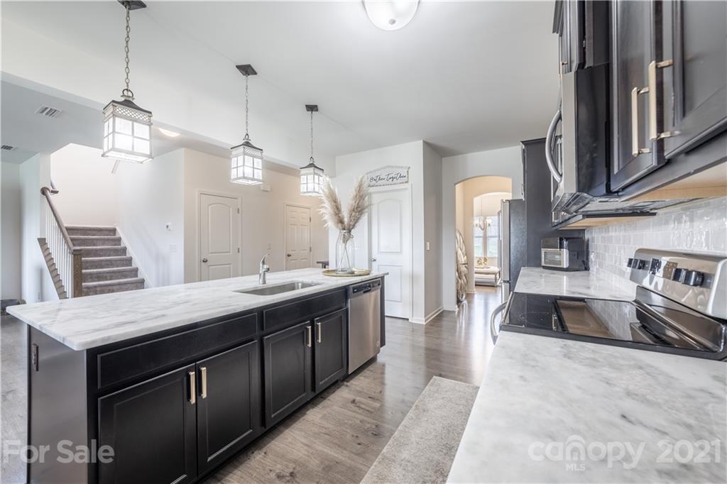 515 Comfort Way Locust, NC 28097 - Photo 11 of 31 a large kitchen with stainless steel appliances kitchen island granite countertop a sink and a stove