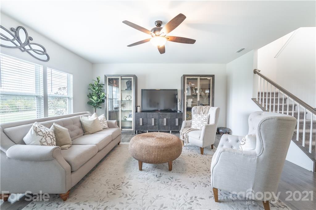 515 Comfort Way Locust, NC 28097 - Photo 14 of 31 a living room with furniture a flat screen tv and a large window