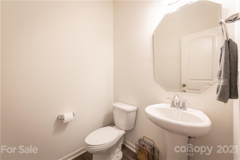 515 Comfort Way Locust, NC 28097 - Photo 16 of 31 a bathroom with a toilet a sink and a mirror
