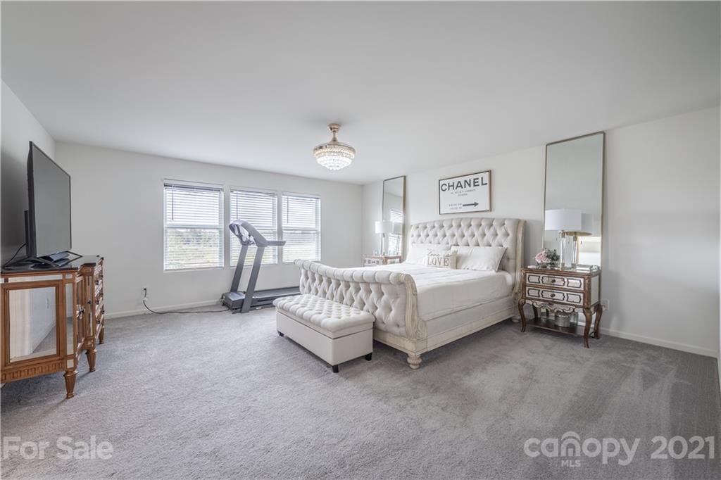 515 Comfort Way Locust, NC 28097 - Photo 23 of 31 a spacious bedroom with a bed and a couch