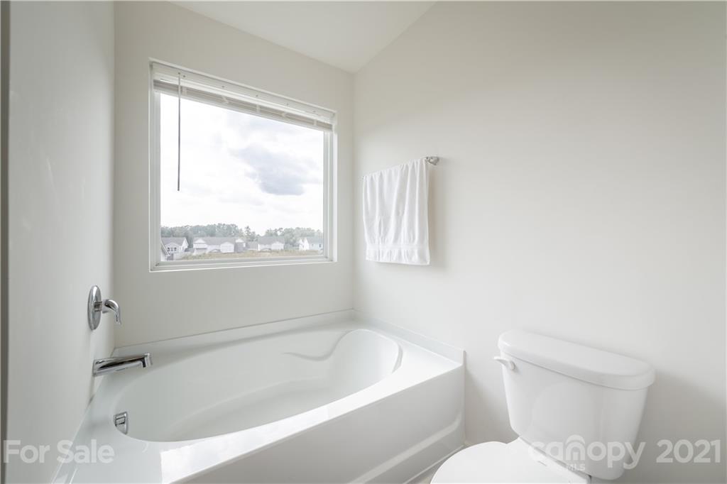 515 Comfort Way Locust, NC 28097 - Photo 26 of 31 a white bath tub sitting next to a toilet