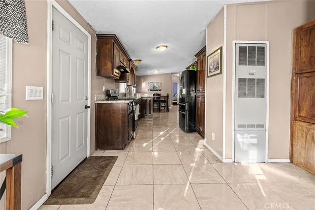 a large bed sitting in a bedroom next to a window