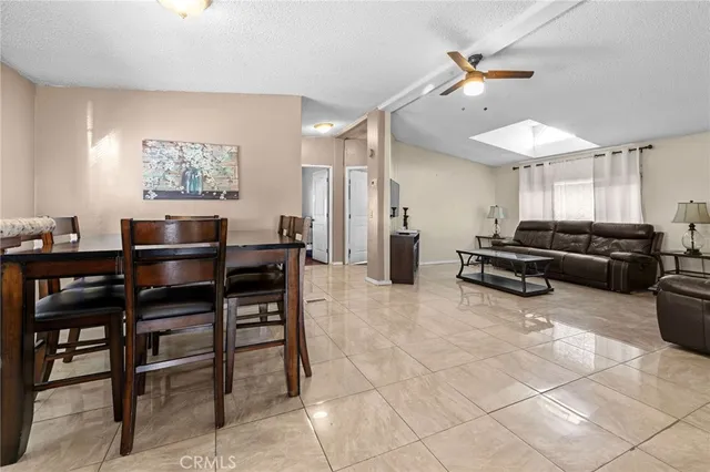 a large bedroom with a bed and a flat screen tv