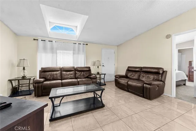 a bedroom with a bed couch and a window