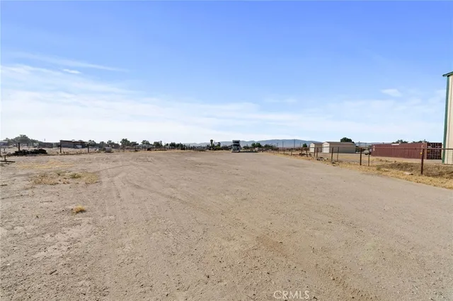a view of house with backyard and parking