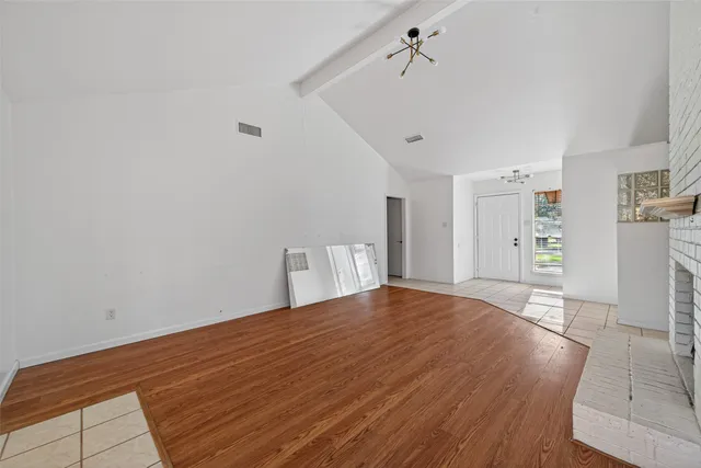 a view of a kitchen with white cabinets and refrigerator