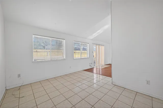 a spacious bedroom with a bed and a chandelier