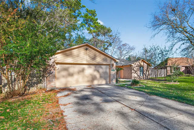 a view of a house with a yard and pathway