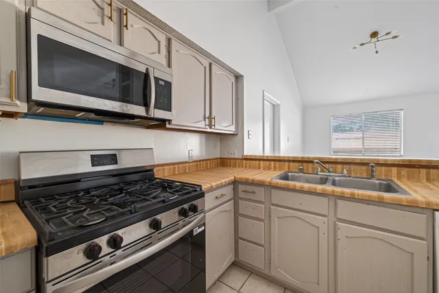 a kitchen with a sink a stove cabinets and counter space