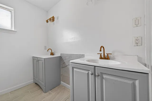 a bathroom with a sink and mirror