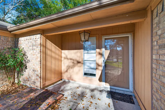 a view of an empty room with window and cabinet