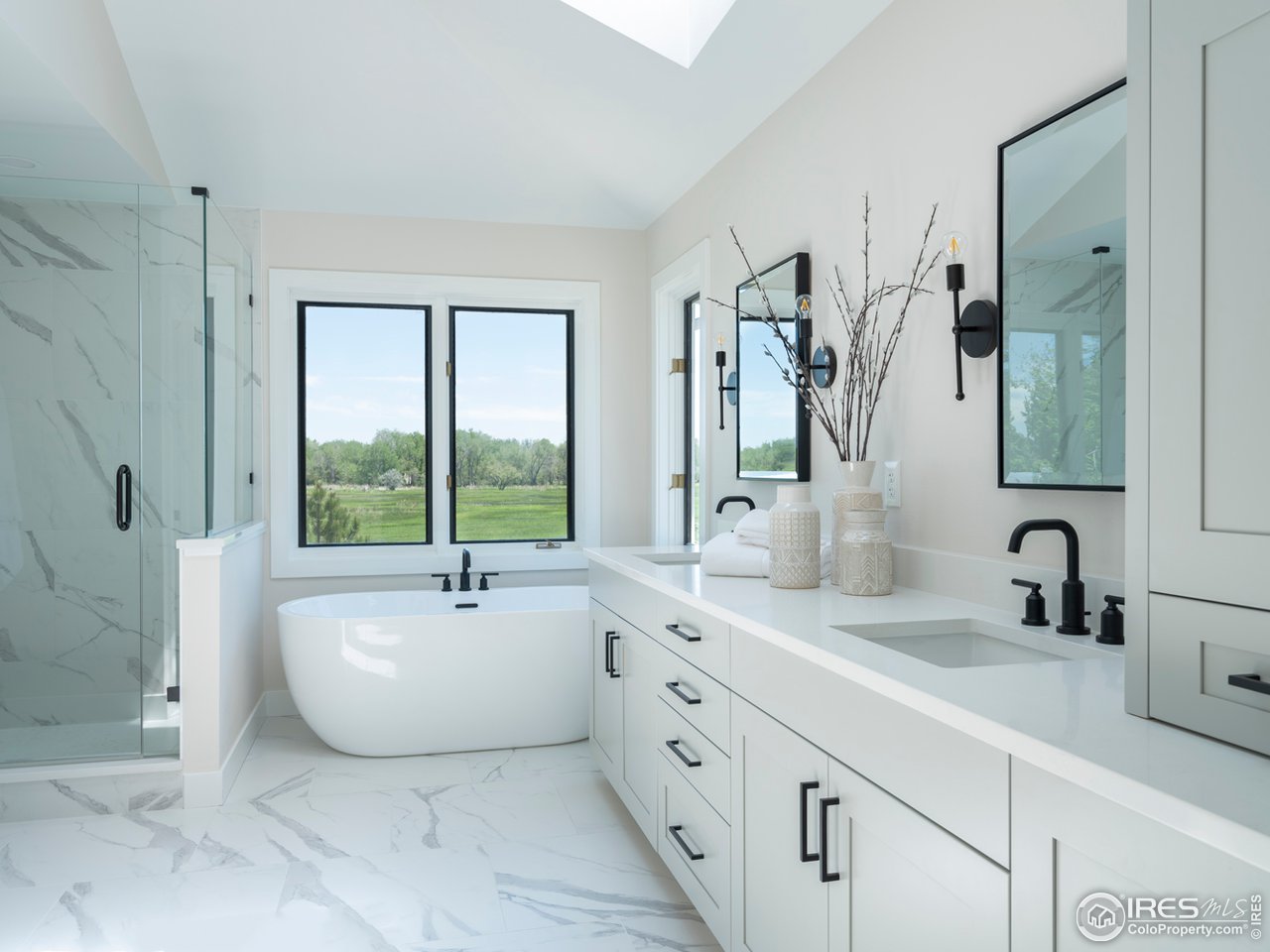 5685 Euclid Place Boulder, CO 80303 - Photo 19 of 38 a bathroom with a double vanity sink mirror and window