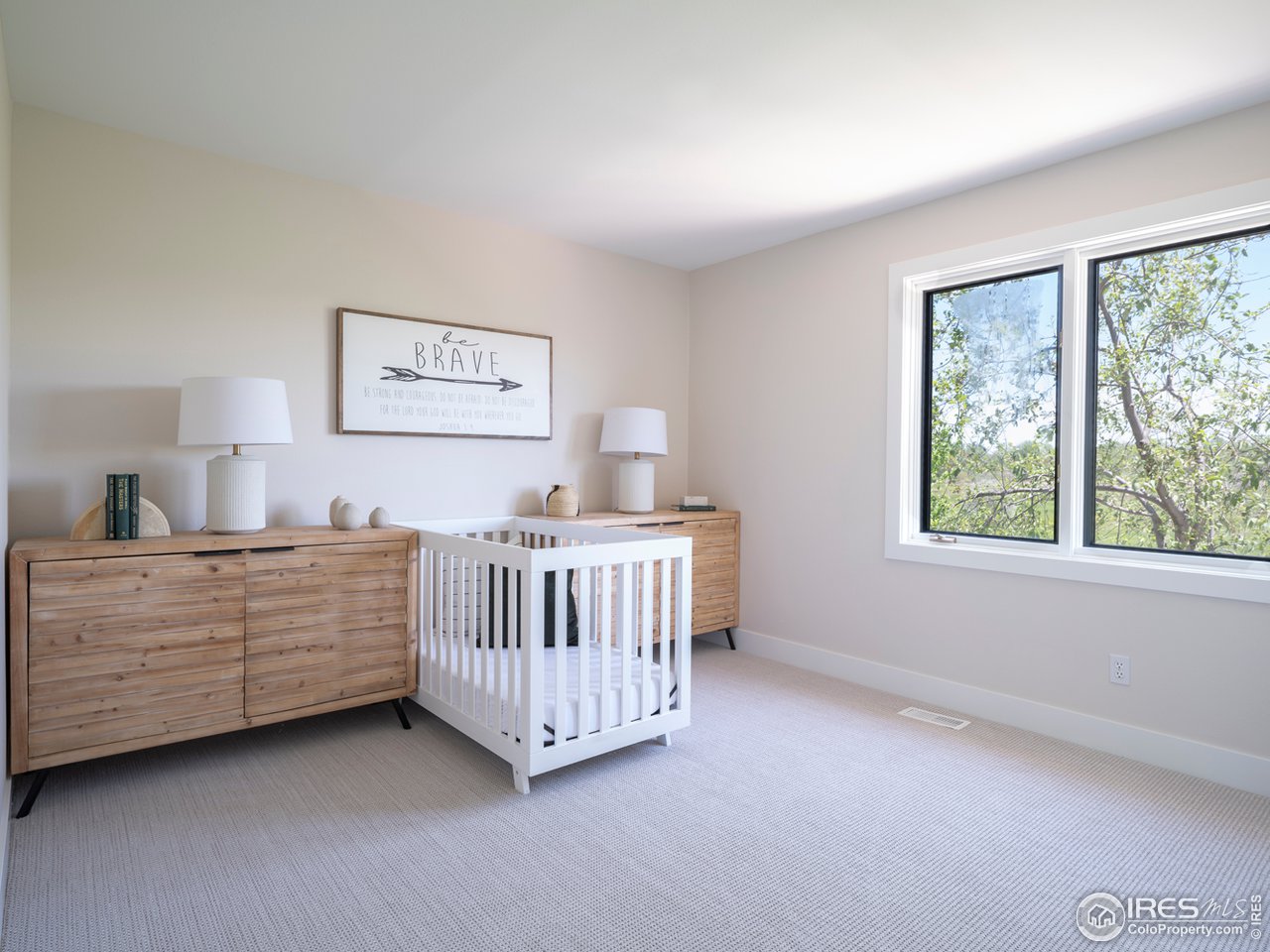5685 Euclid Place Boulder, CO 80303 - Photo 24 of 38 a view of a bedroom with a baby bed baby crib and a window