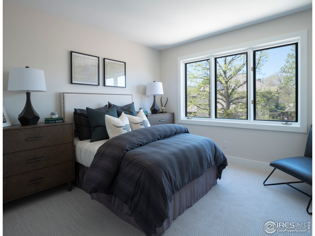 5685 Euclid Place Boulder, CO 80303 - Photo 26 of 38 a bedroom with a bed a lamp and window