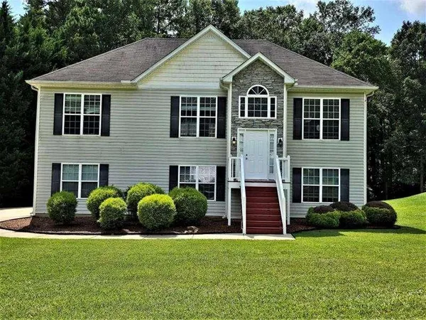 a front view of a house with a garden