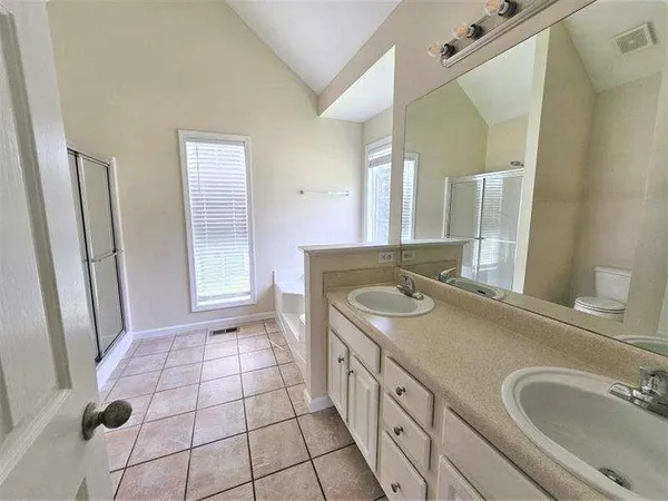 a bathroom with a sink a toilet a mirror and vanity