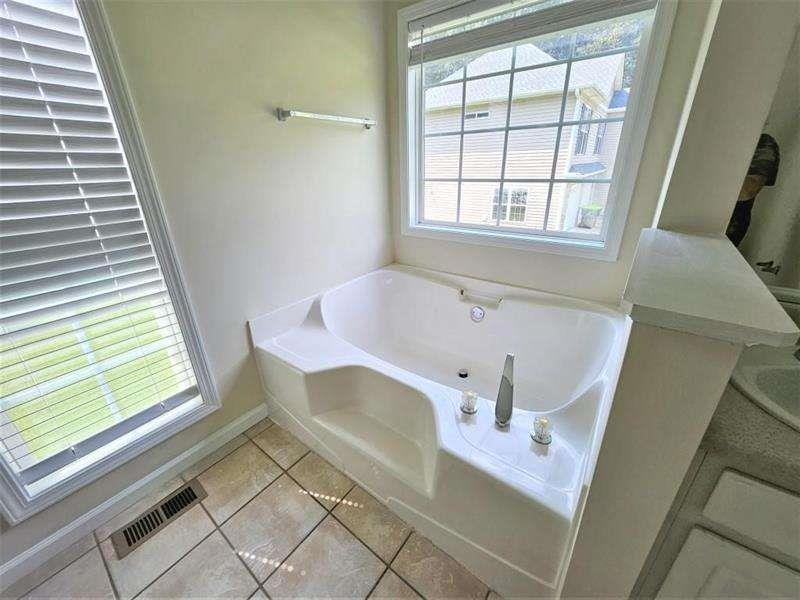 197 Meadow Spring Court Temple, GA 30179 - Photo 18 of 29 a bath tub sitting in a bathroom next to a window